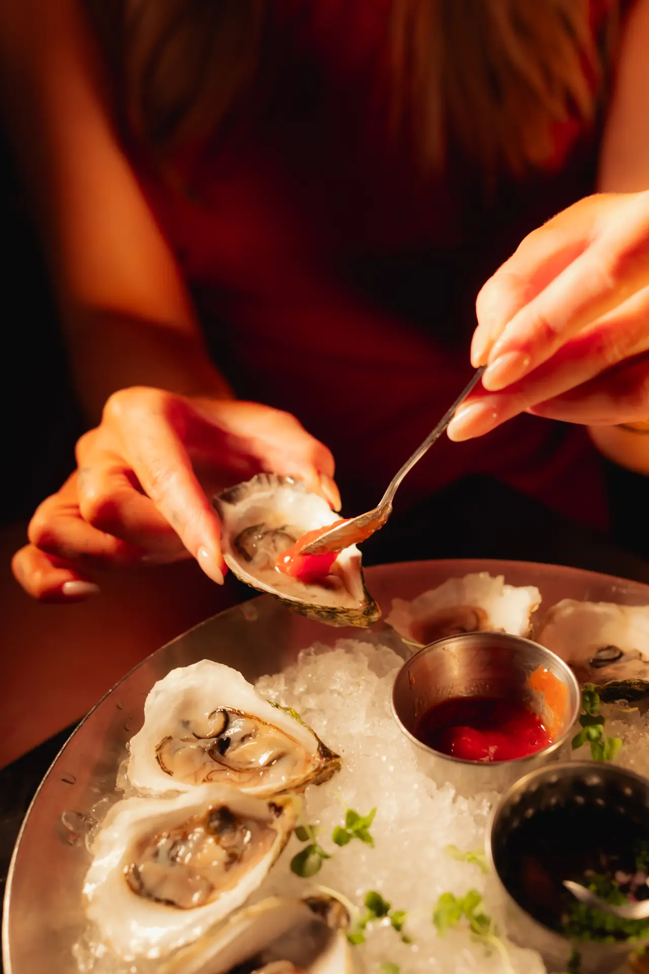 Mignonette spooned onto oysters on ice
