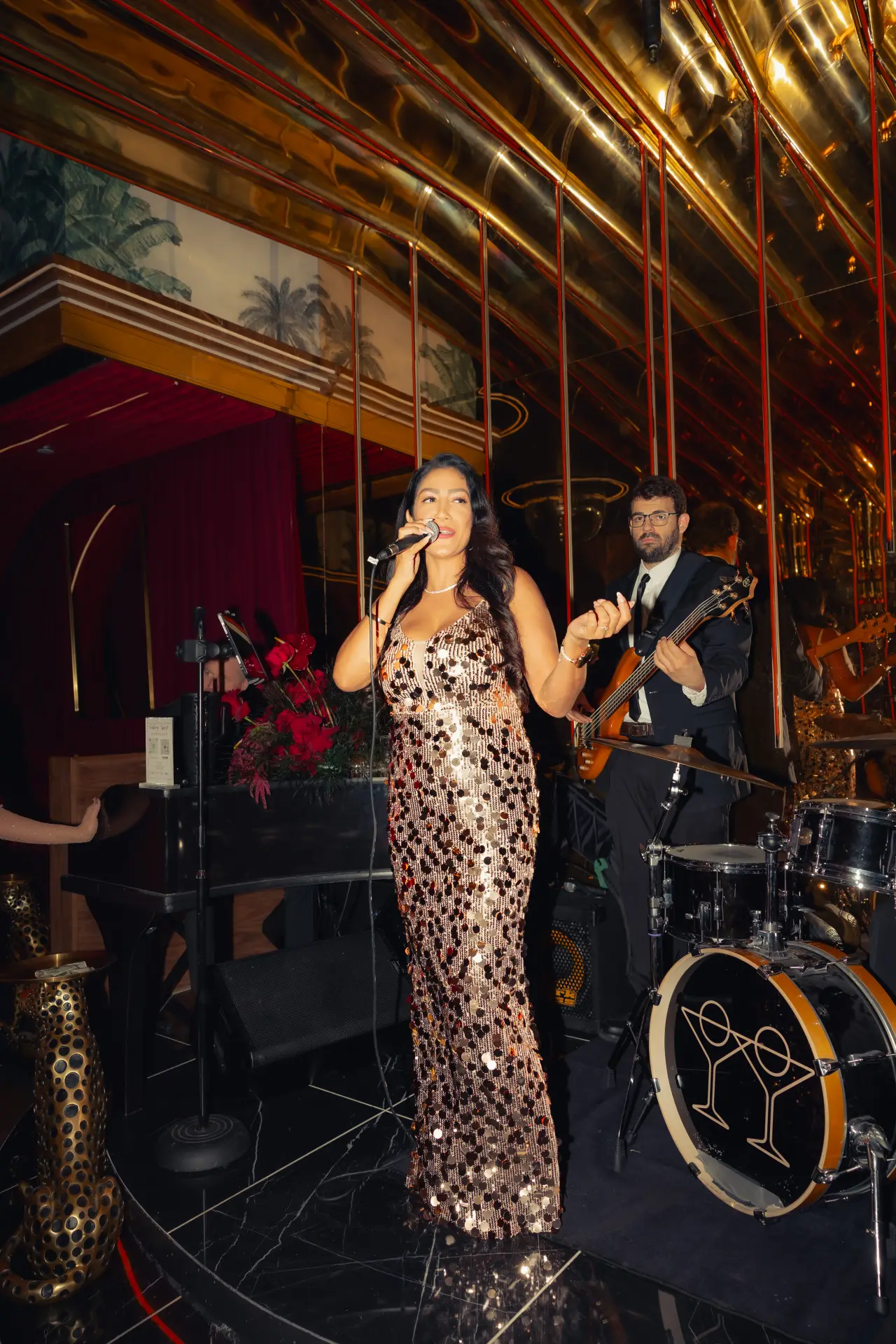 A jazz singer with the live band at Tell Your Friends