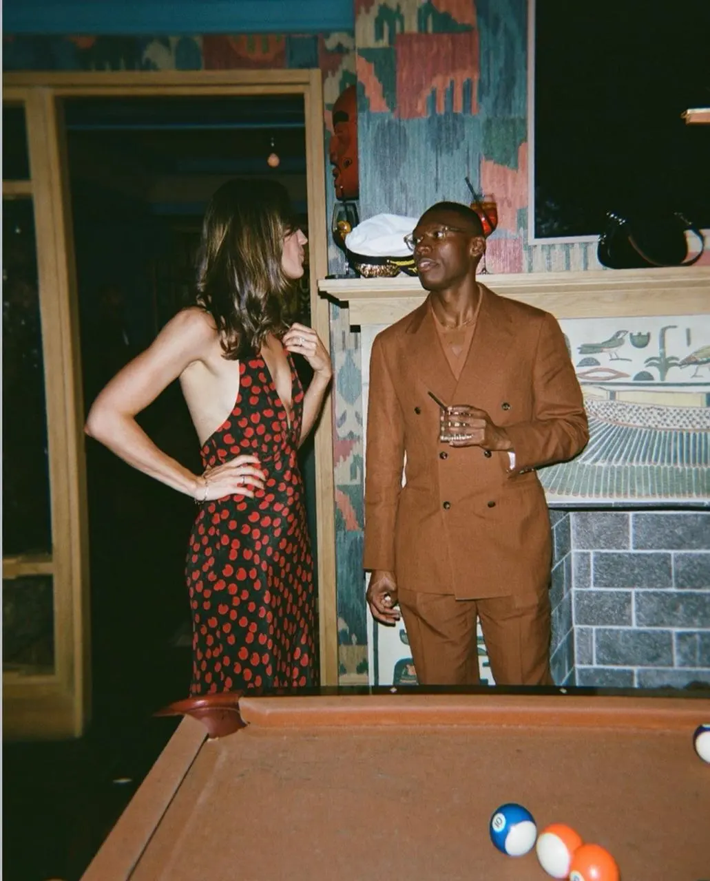 A couple dressed up by the billiards table