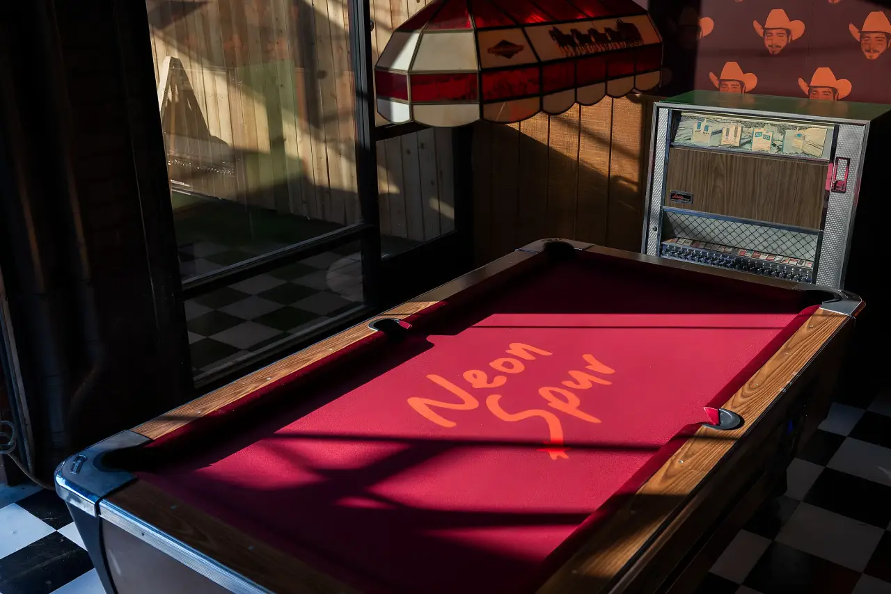 The pool table and jukebox at Neon Spur