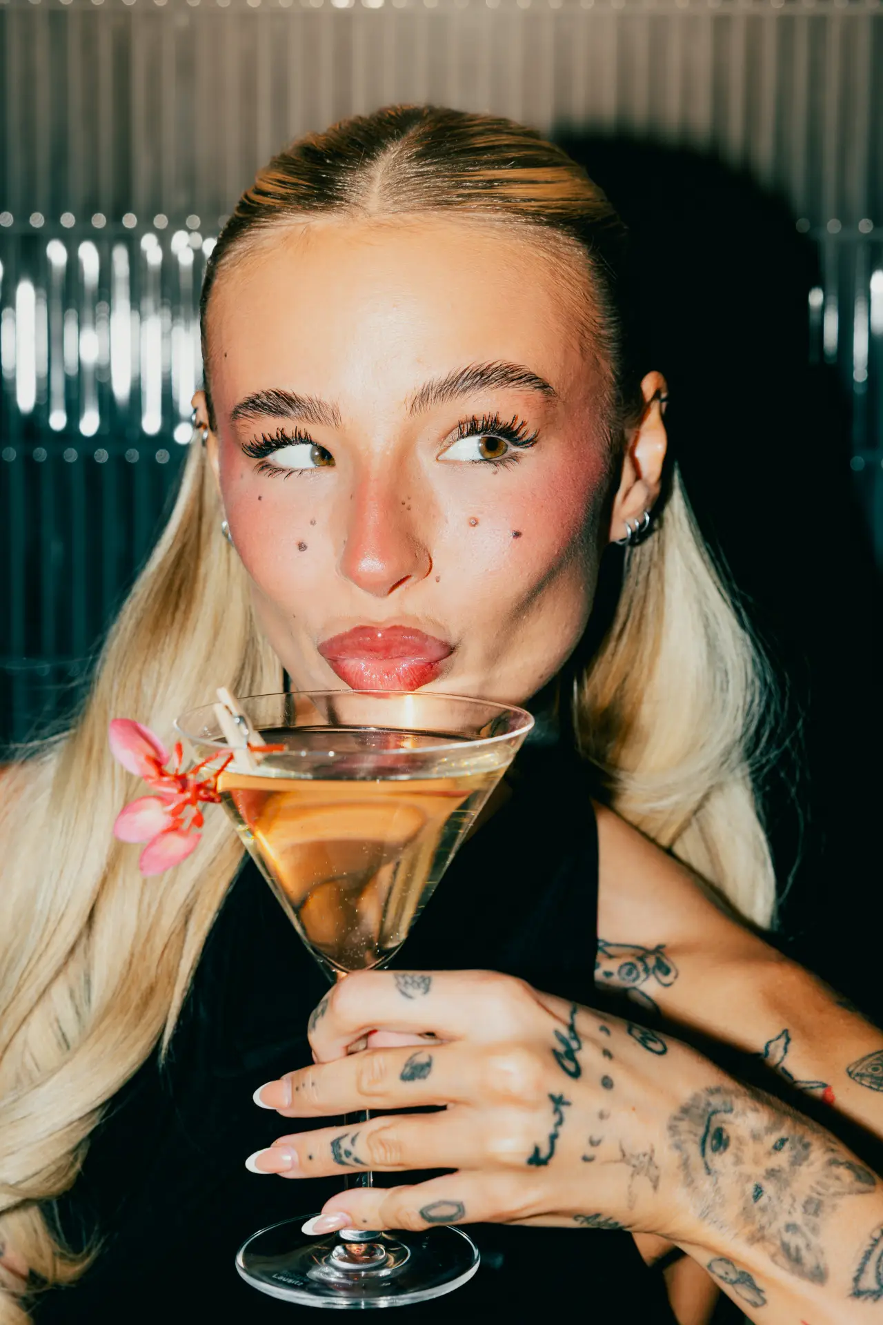 A guest with a martini at KUZA