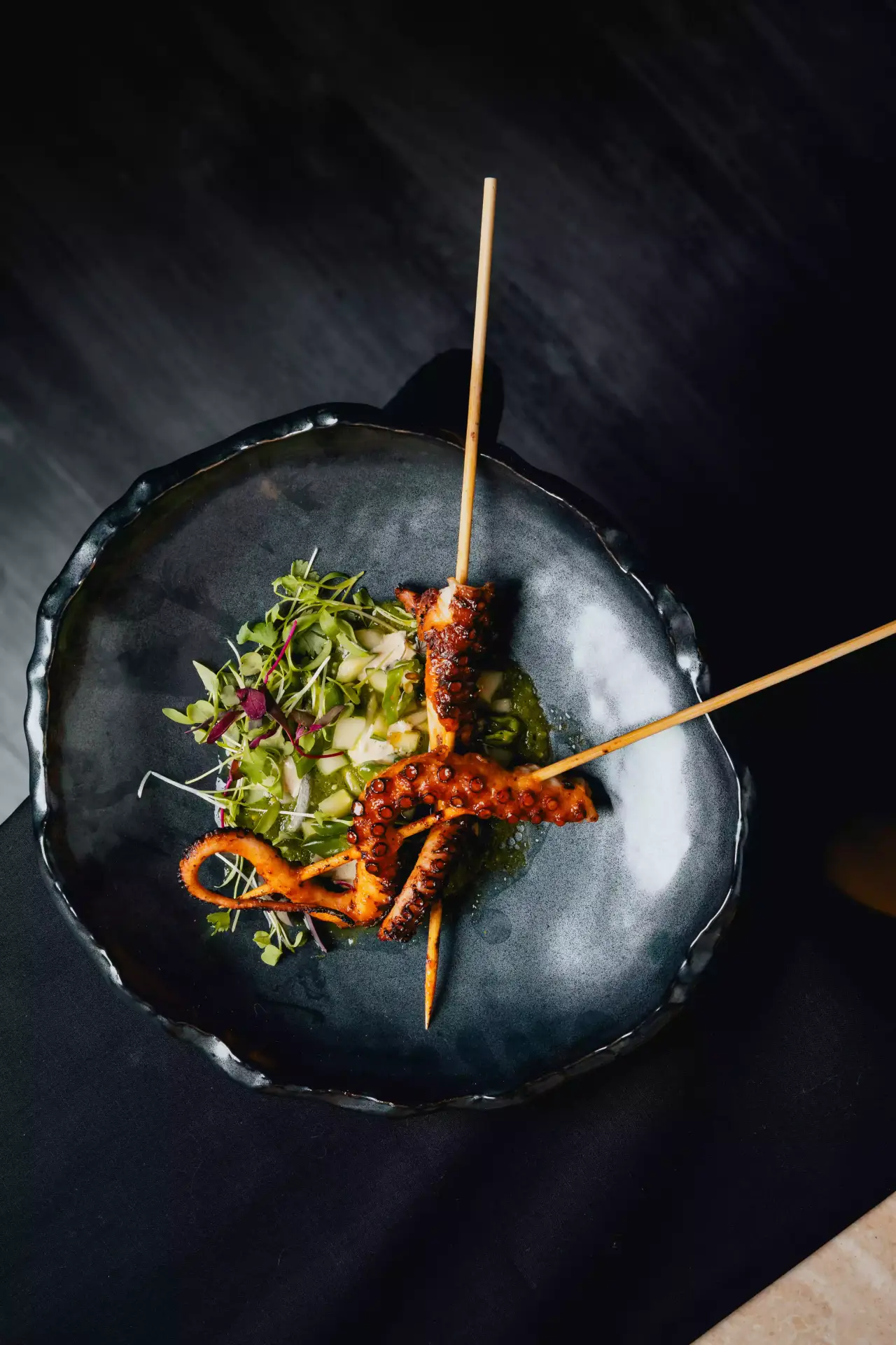 Grilled octopus skewers with microgreens